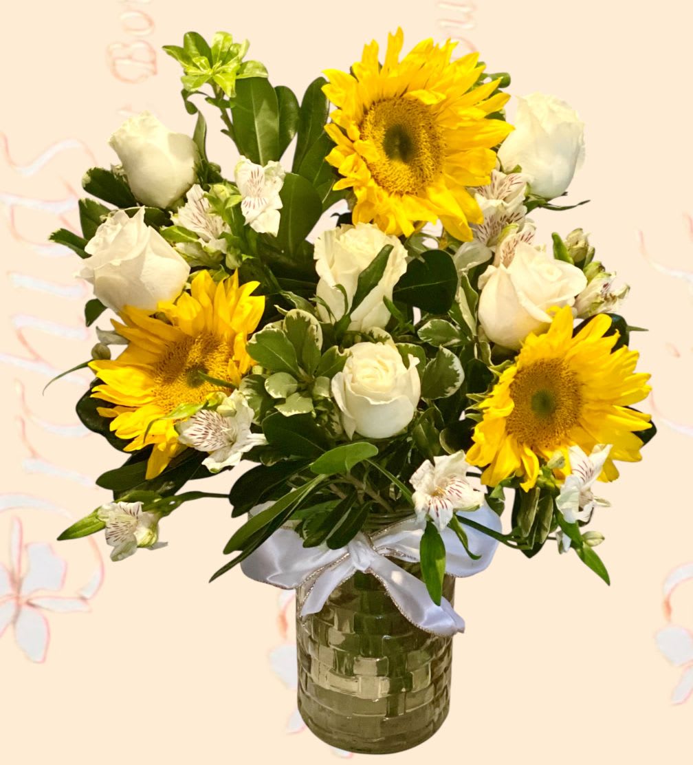 Bouquet of sunflowers and white roses in a glass vase
