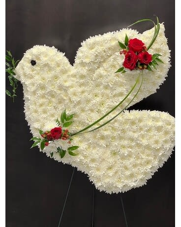 White floral dove-shaped standing spray with red rose accents