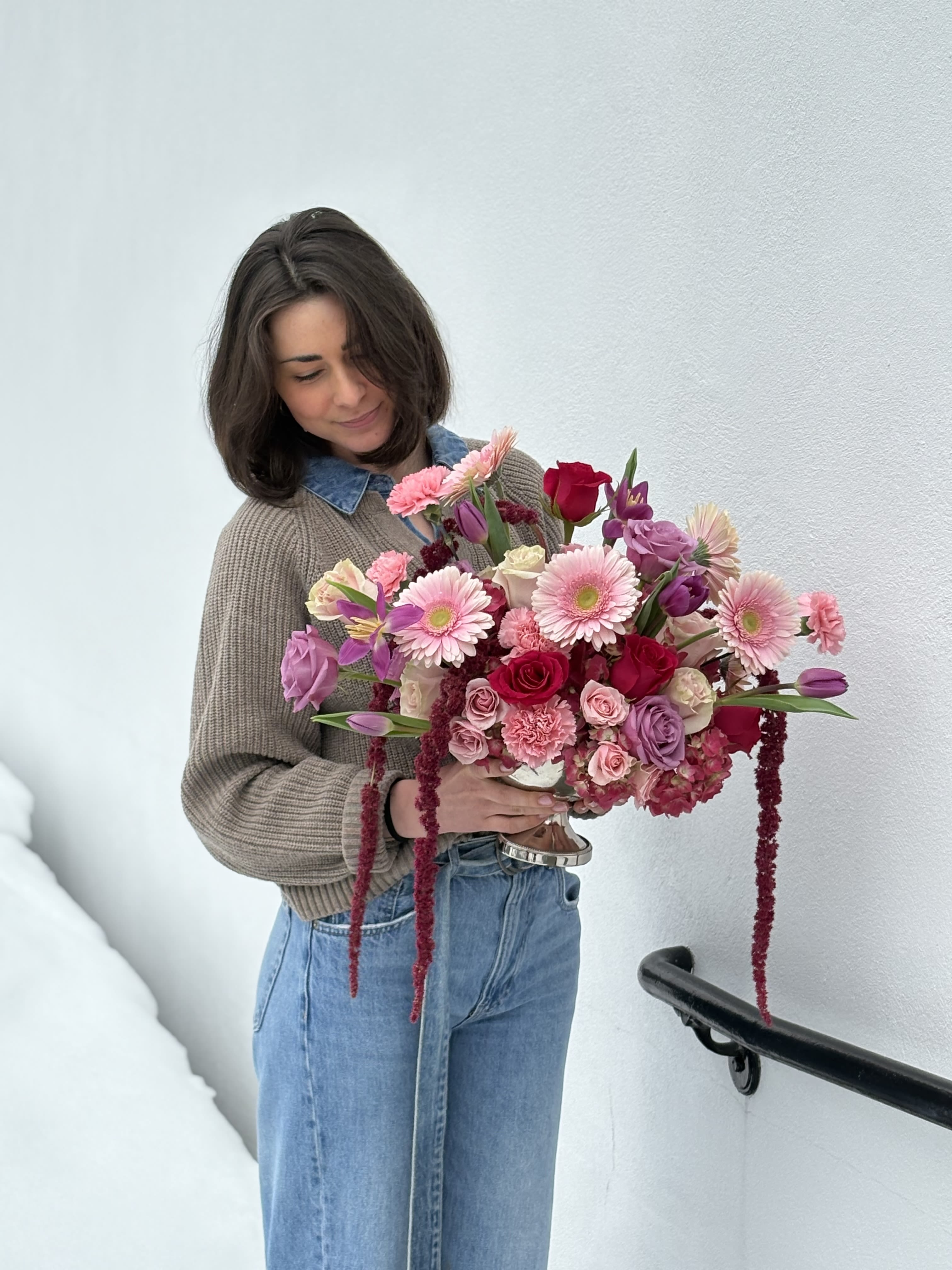 Woman holding a large pink and purple bouquet
