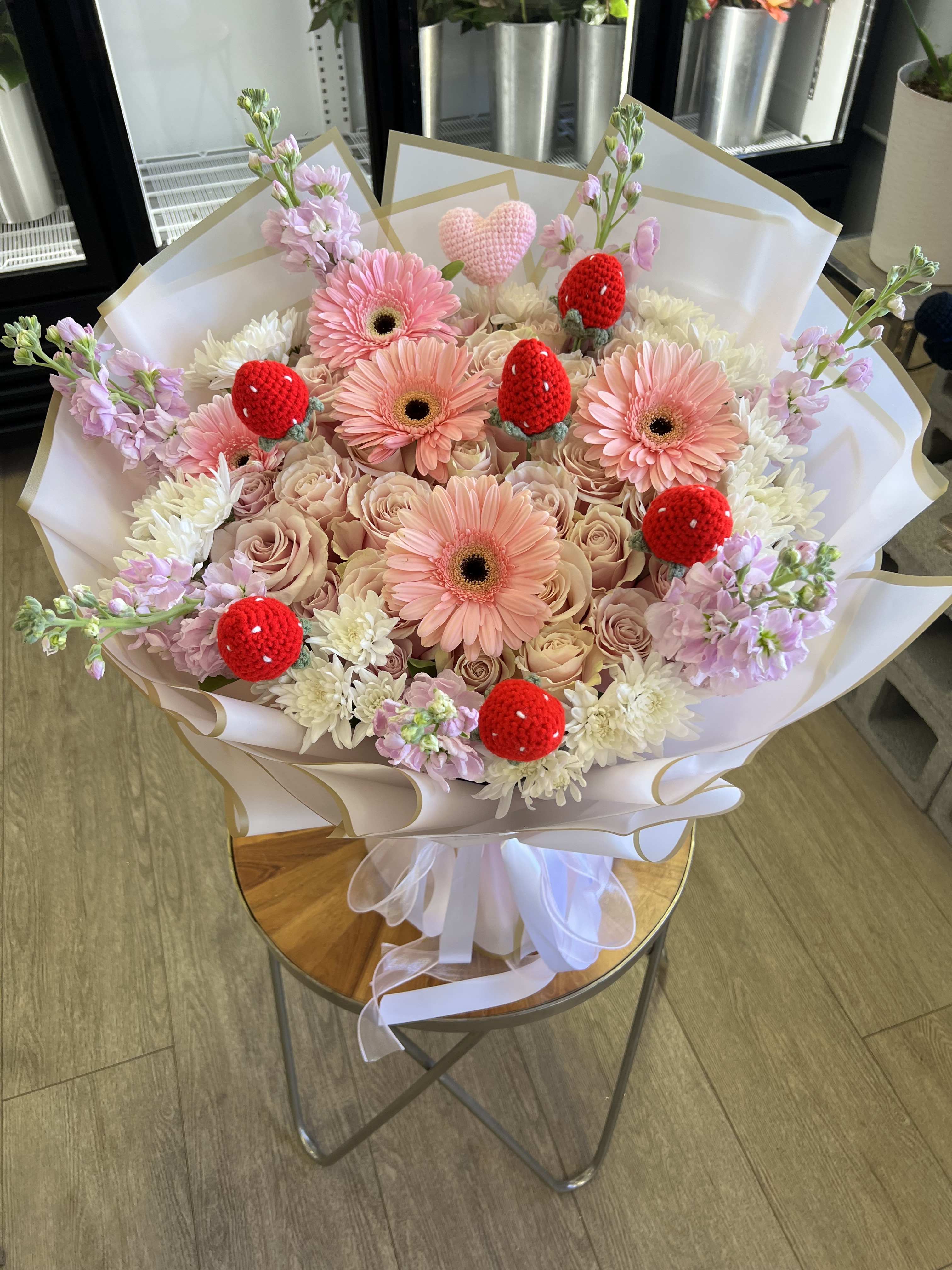 Pink gerbera and roses bouquet with red strawberry decorations