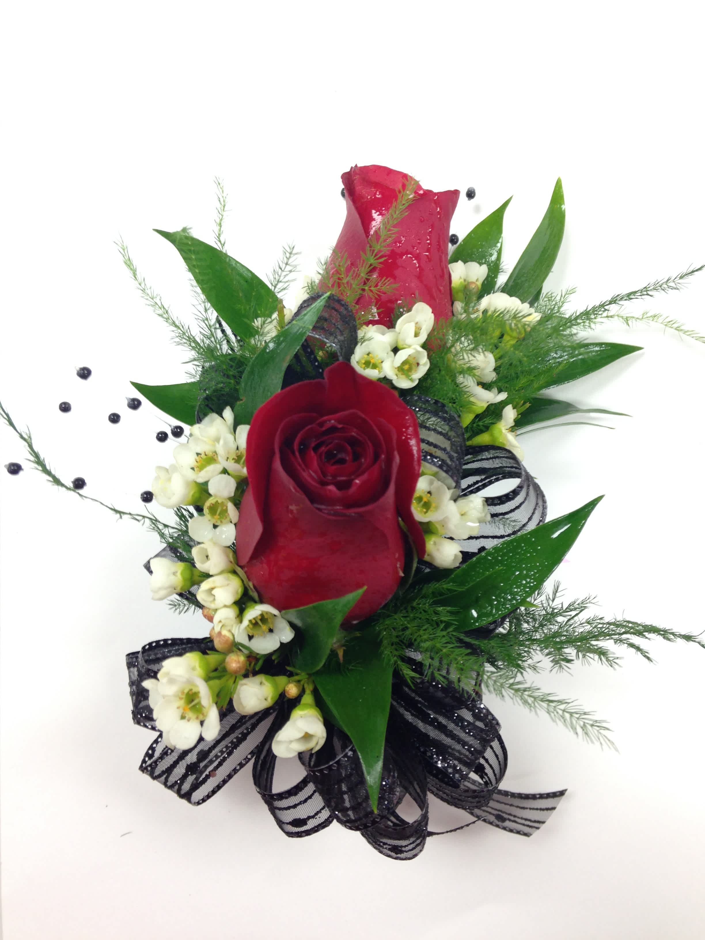 Two Red Rose Corsage - Colors and ribbons may vary. When ordering please specify color of dress, color of roses preferred and color of ribbon preferred in order notes. Please include 2nd choice for ribbon colors. We will call you by phone if preferred ribbon color is unavailable.