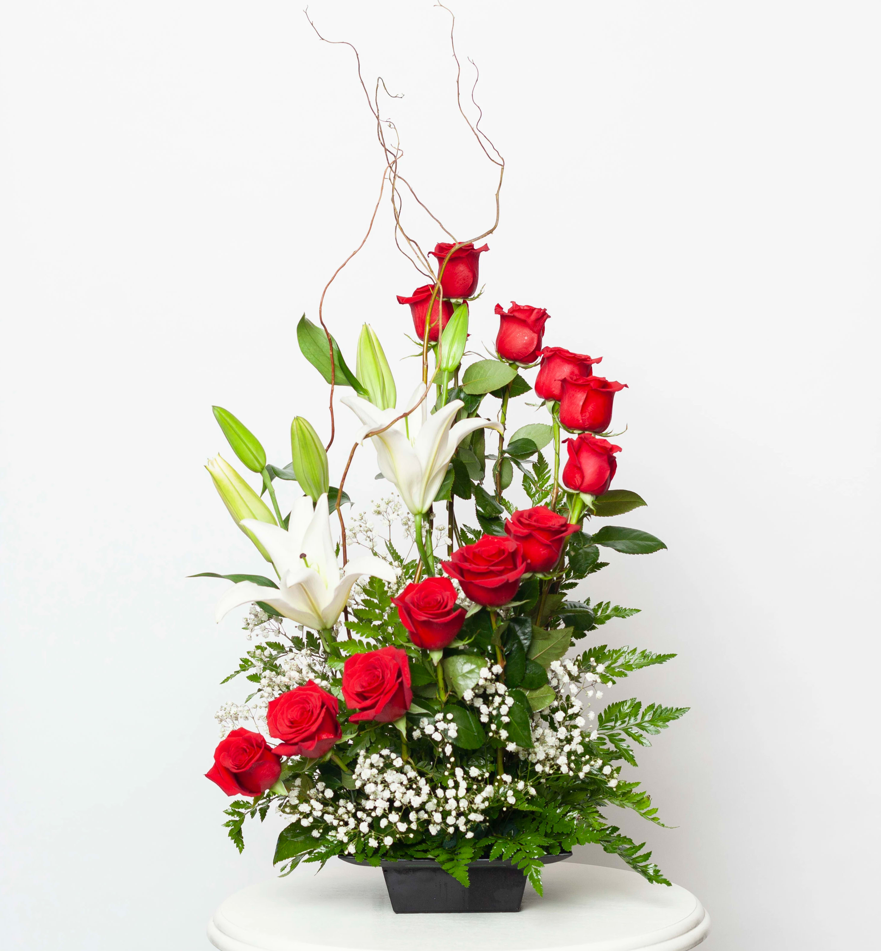 Red roses and white lilies in a black container