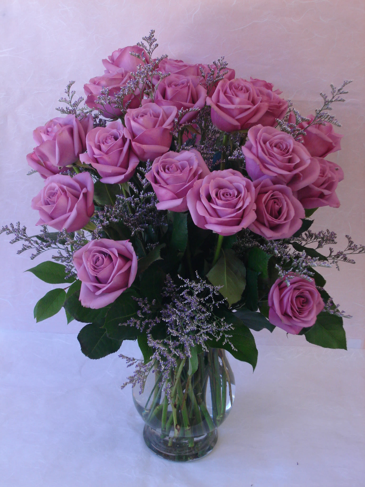 Pink roses arranged in a clear glass vase