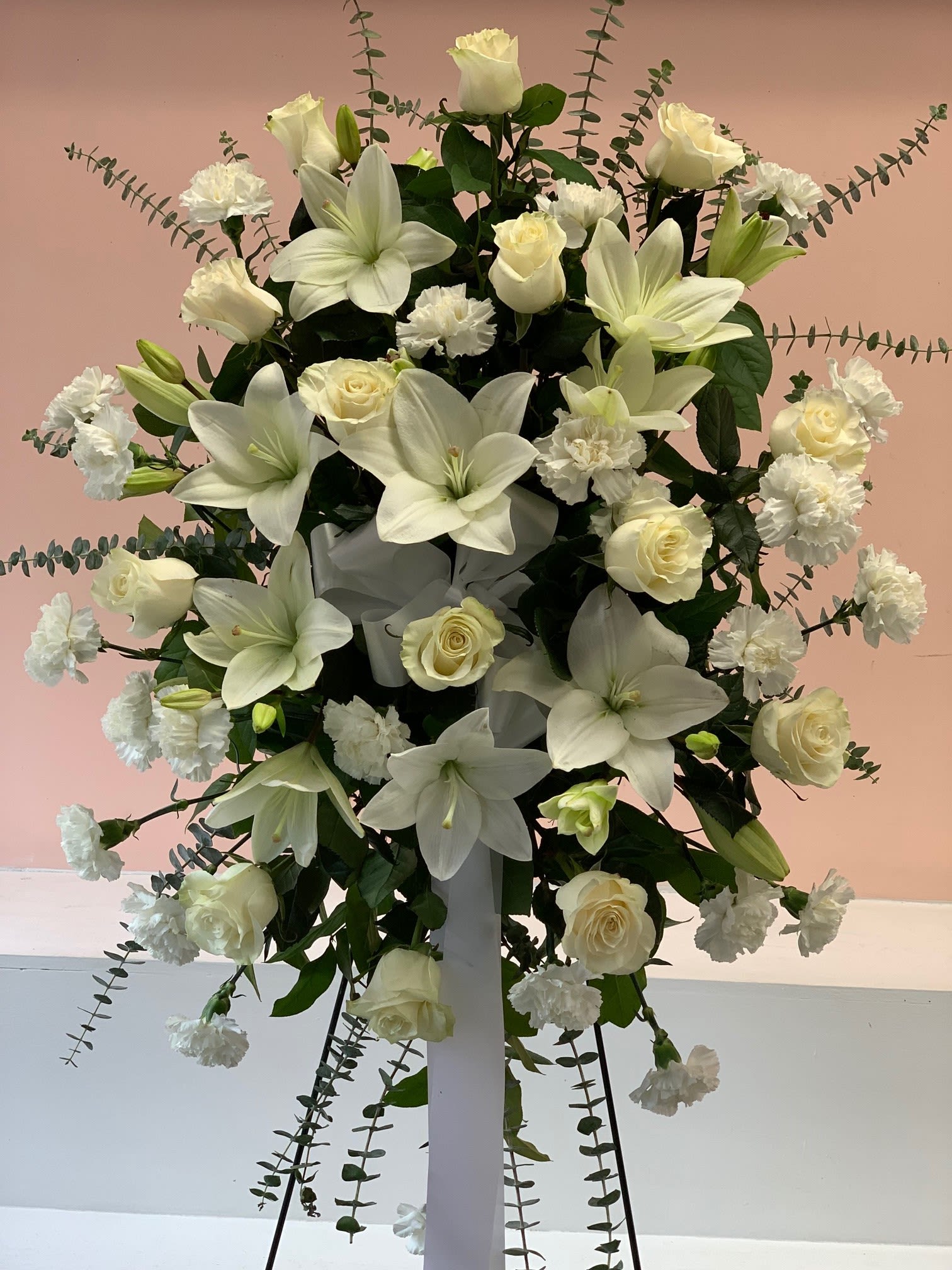 Pure Respect - Sending a beautiful standing spray is the perfect way to pay your respects to a deceased loved one. Pure Respect flower standing spray is made with fresh white Asiatic Lilies, Roses, Carnations and Eucalyptus. Fillmore Florist San Francisco is full service San Francisco flower delivery shop. Dimensions Approximately: 75" H x 35" W