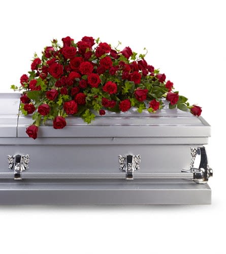 Red rose casket spray on a silver coffin