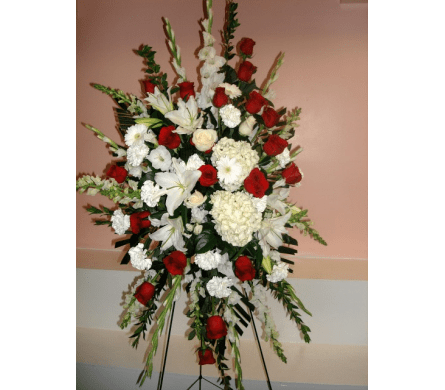 Honor and Love Standing Spray - W488 - This is a floral Standing Spray that is designed with white Lilies Hydrangeas Roses Gladiolus Snapdragon Carnations Gerbera Daisies Stocks and premium red Roses. This Red and White Roses Standing Spray is appropriate for all special events including sympathy funeral corporate events or any other important occasion.Dimensions Approximately: 75" H x 30" W As Shown : W488