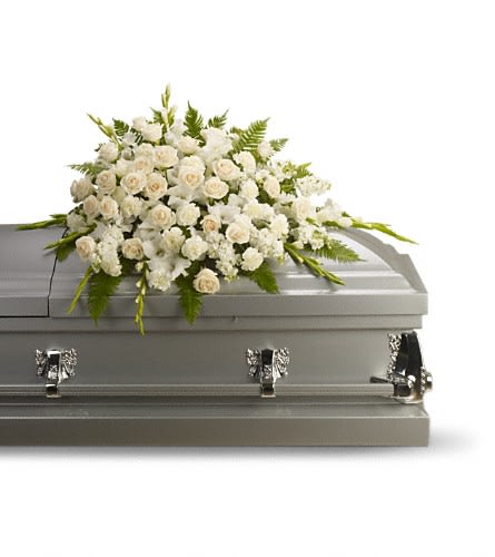 White floral spray on a gray casket