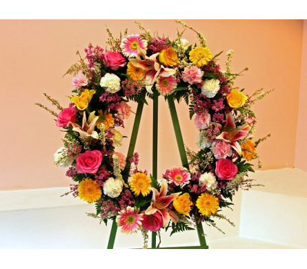 Colorful floral wreath on a green easel