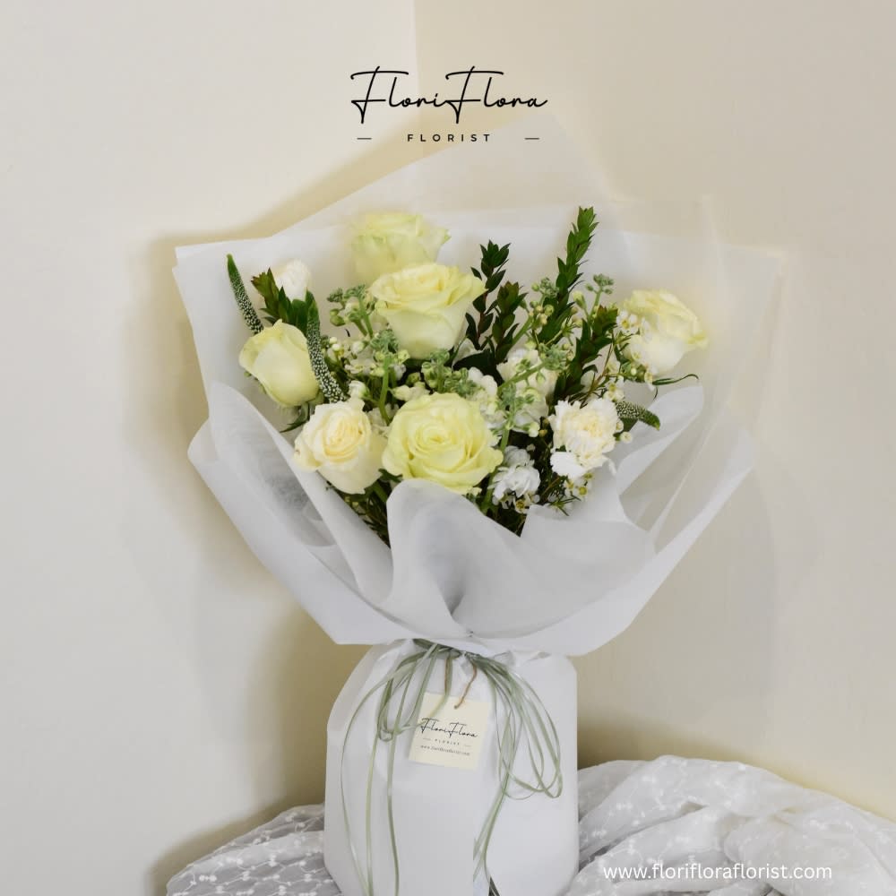 In My Heart - In My Heart is a soft, elegant bouquet that feels like a warm embrace from afar. Creamy white roses are gathered with delicate filler blooms and fresh greenery, then wrapped in airy white paper that lets every petal and leaf gently shine. The muted tones and graceful shape give this bouquet a quietly romantic, thoughtful feel—perfect for saying “you’re always in my heart,” whether you’re missing someone, thanking them, or simply reminding them how much they mean to you.