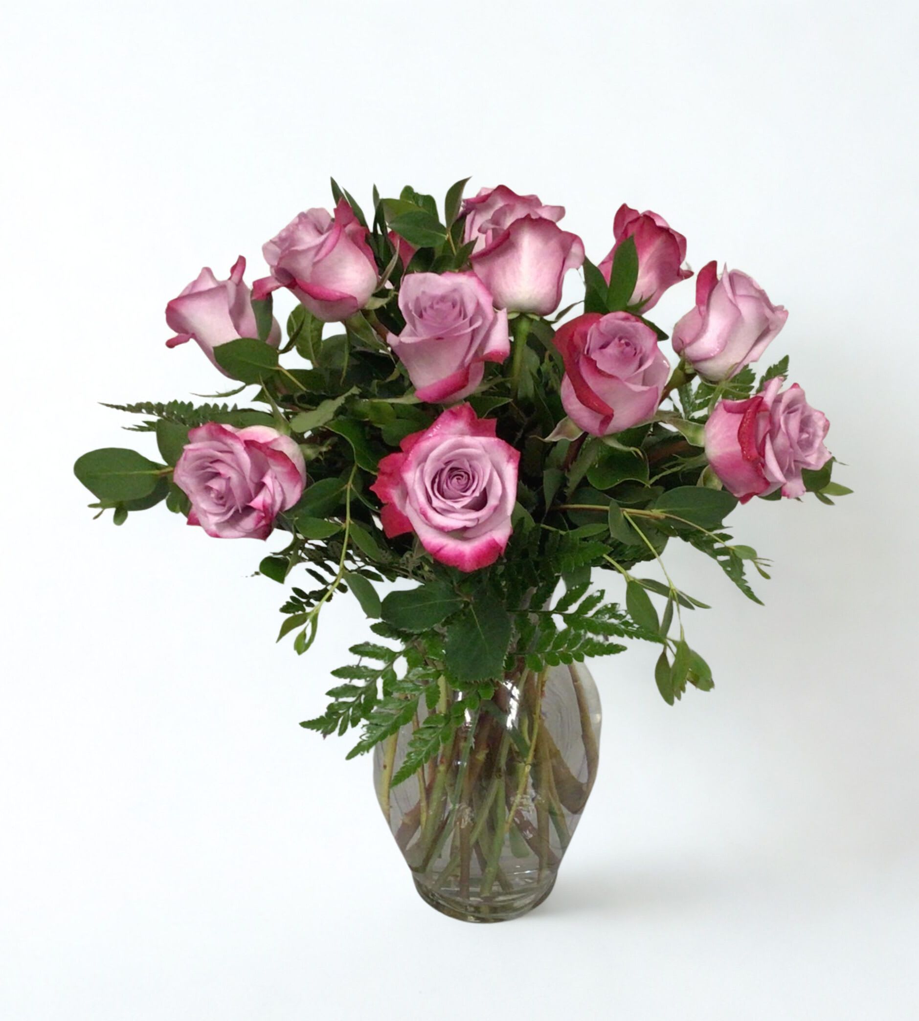 Pink roses arranged in a clear glass vase