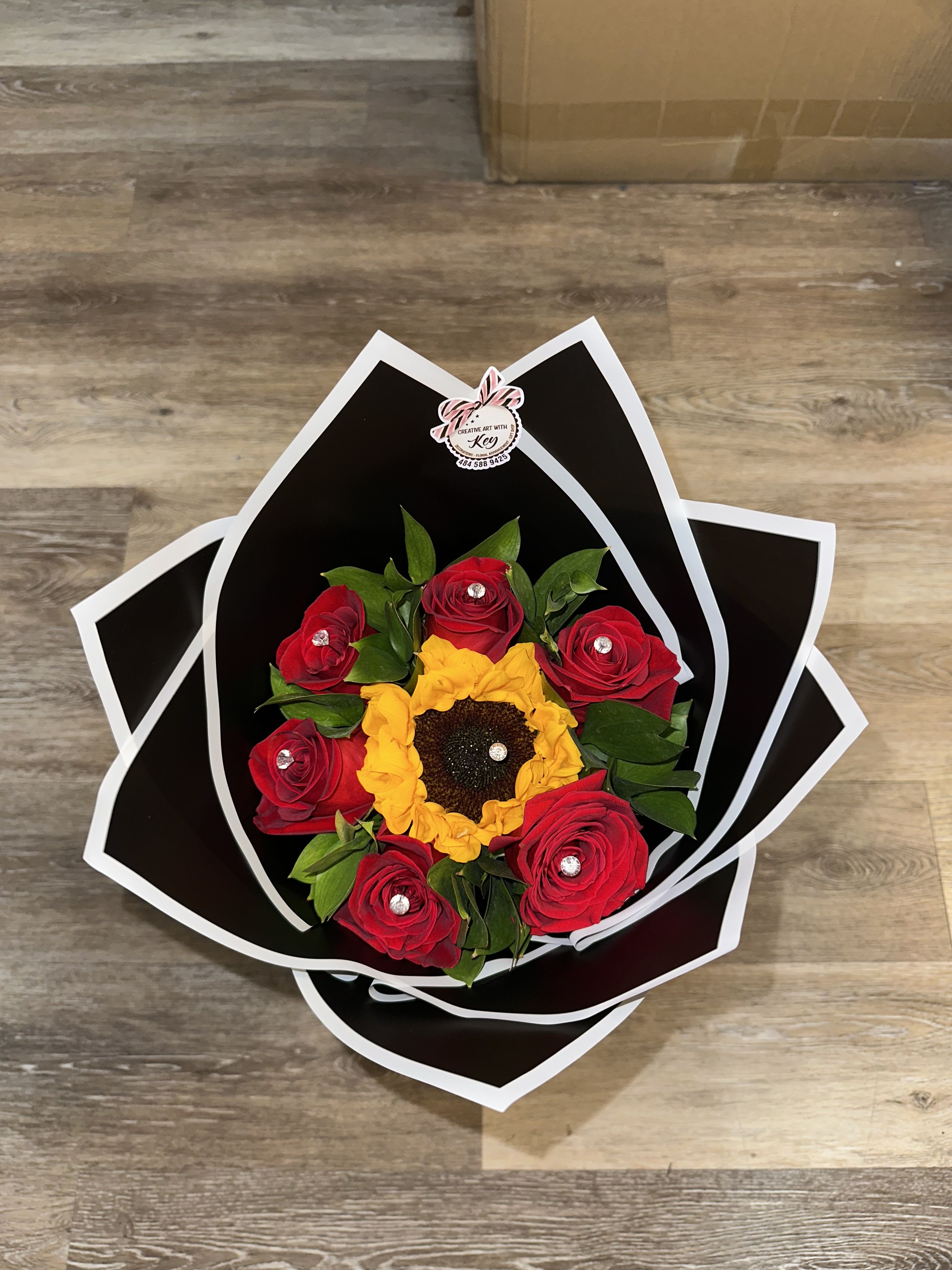 today special bouquet - sunflower and red roses bouquet wrapped in black paper, with butterfly detail. 