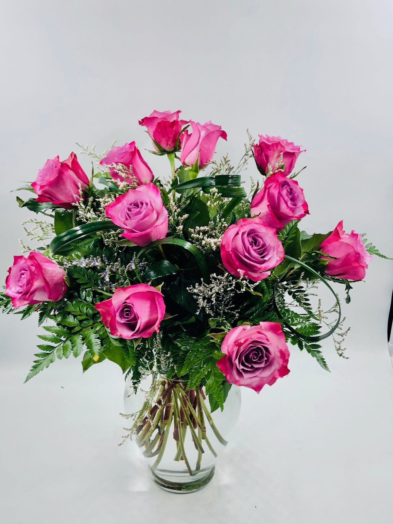 Pink roses arranged in a clear glass vase