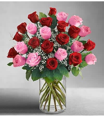Bouquet of red and pink roses in a clear glass vase