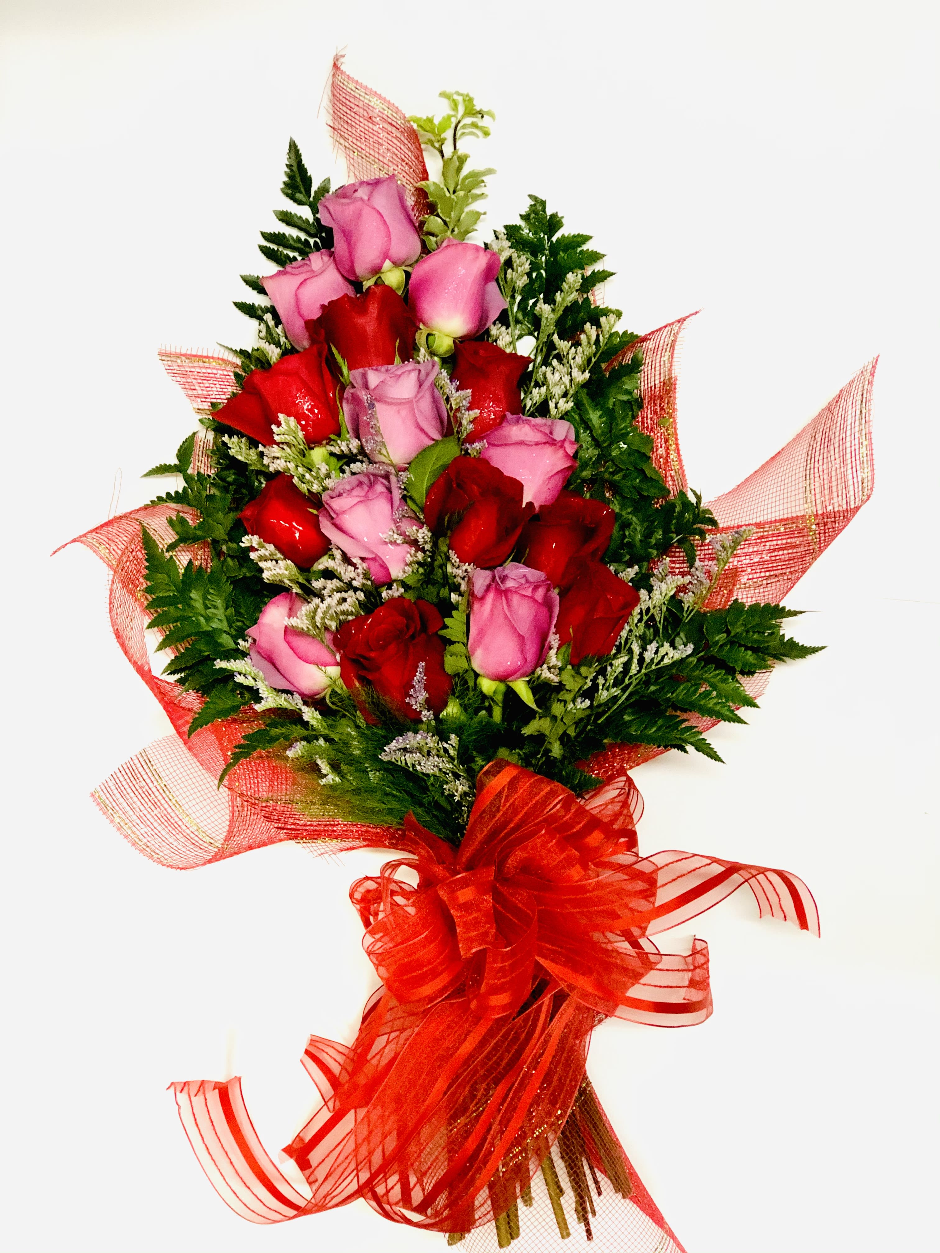 Bouquet of red and pink roses with red ribbon wrap