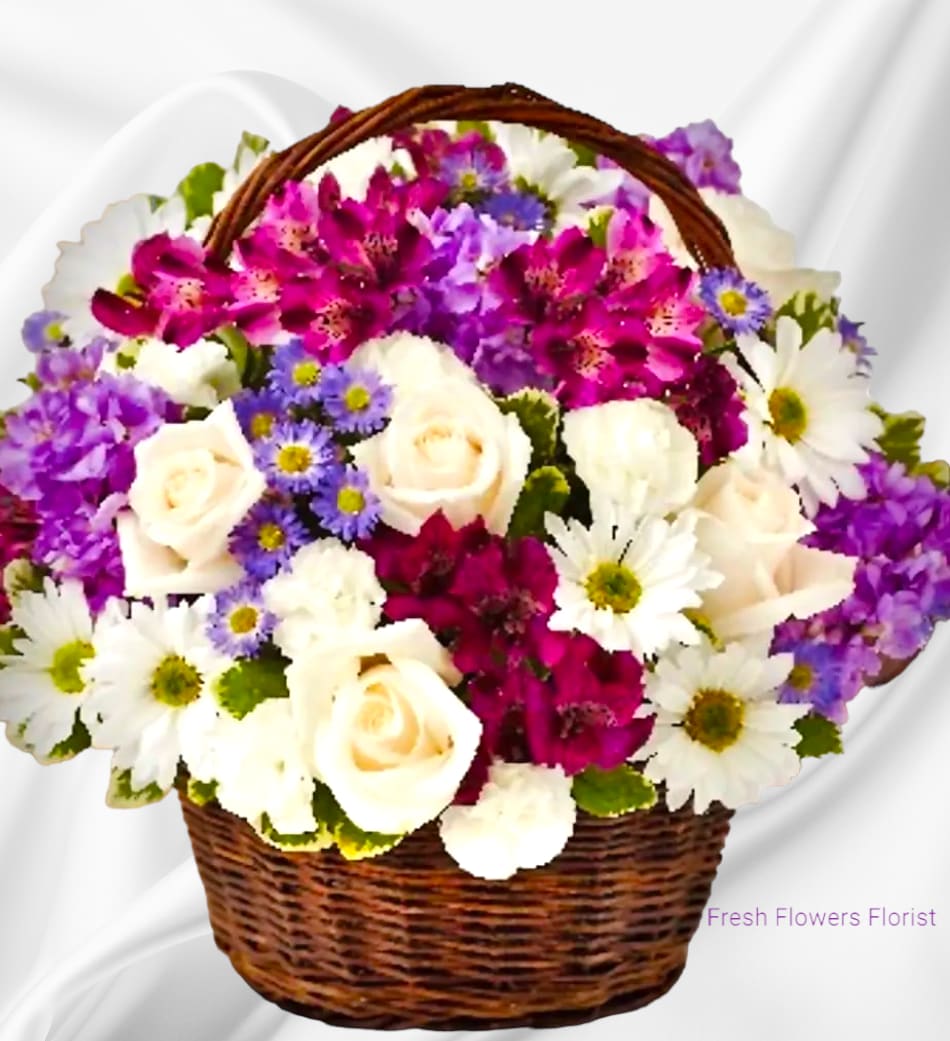 Basket of white roses, daisies, and purple flowers