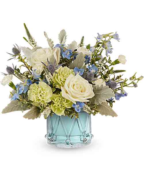 Blue and white floral arrangement in a light blue glass vase