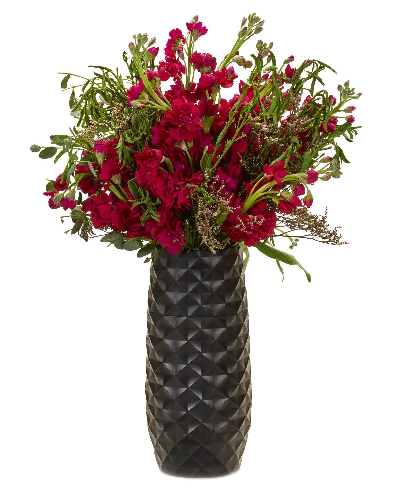 Magenta flower arrangement in a tall black vase