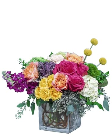Colorful mixed flower arrangement in a square glass vase