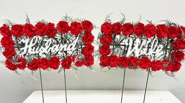 Red floral signs reading Husband and Wife