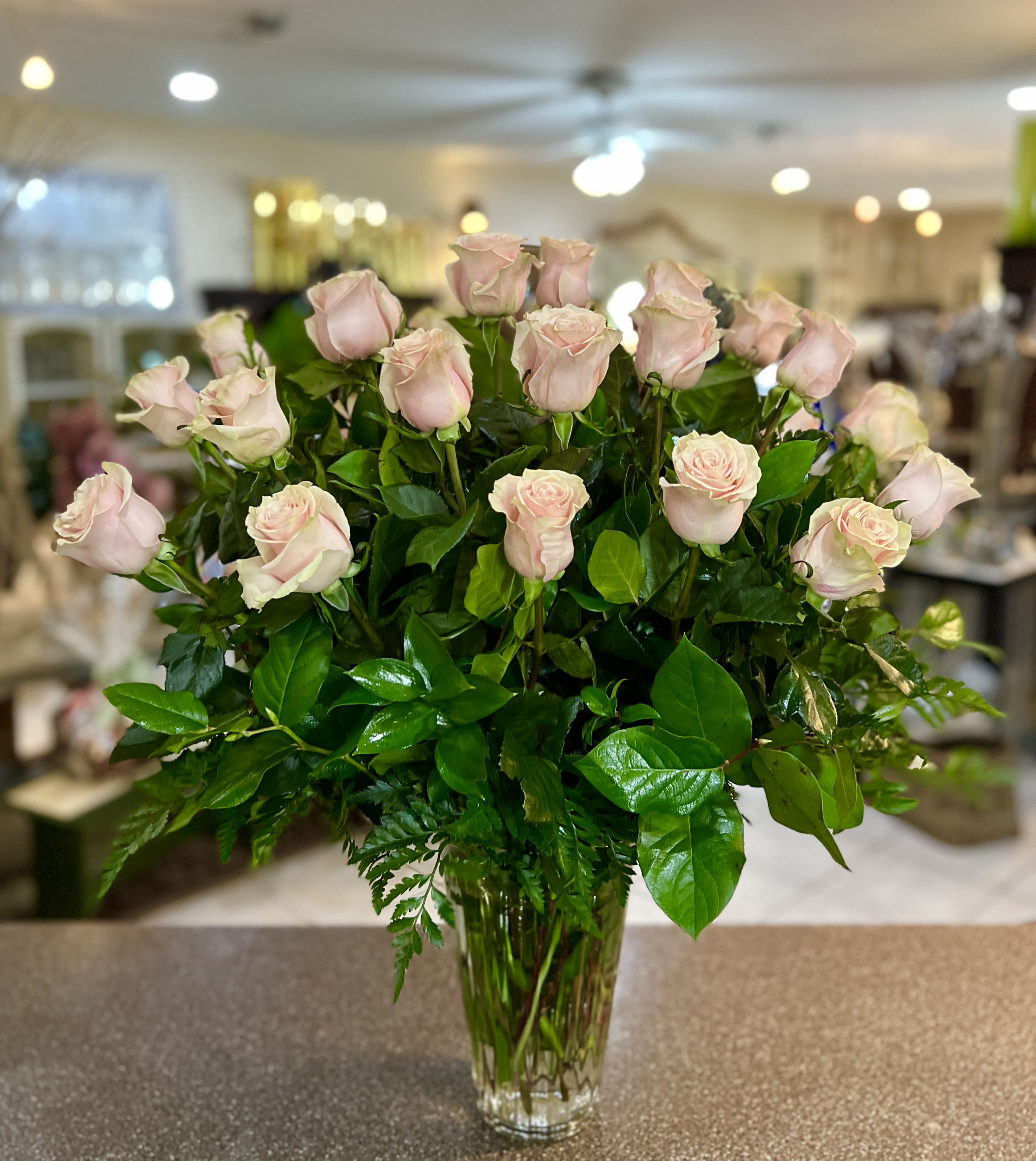 Bouquet of pale pink roses in a clear glass vase