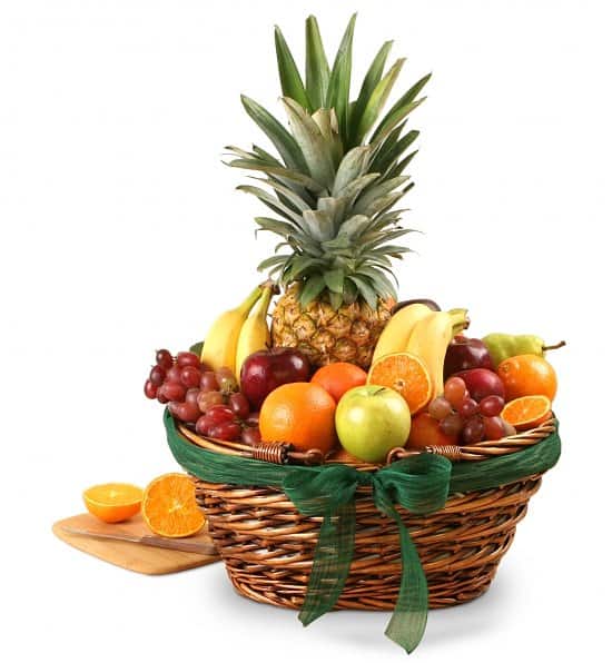 Fruit basket with pineapple, bananas, grapes, oranges, and apples
