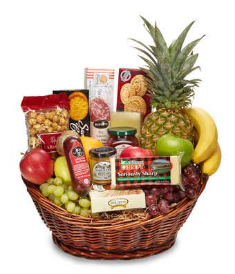 Fruit and snack gift basket with a pineapple, bananas, grapes, and packaged treats