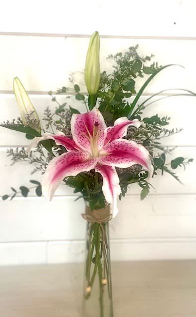 Pink stargazer lily bouquet in a tall glass vase