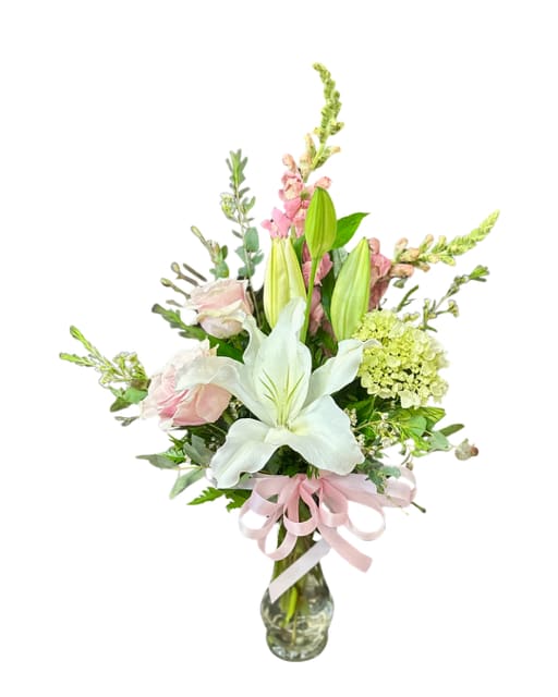 Simply pinks - This vase is filled with blooms just as sweet as mom!  Snap dragons, small hydrangea, roses and a beautiful lily will surely make mom happy.  **Colors of flowers will vary depending on availability