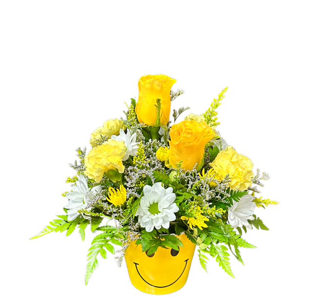 Yellow and white flower arrangement in a smiley-face pot