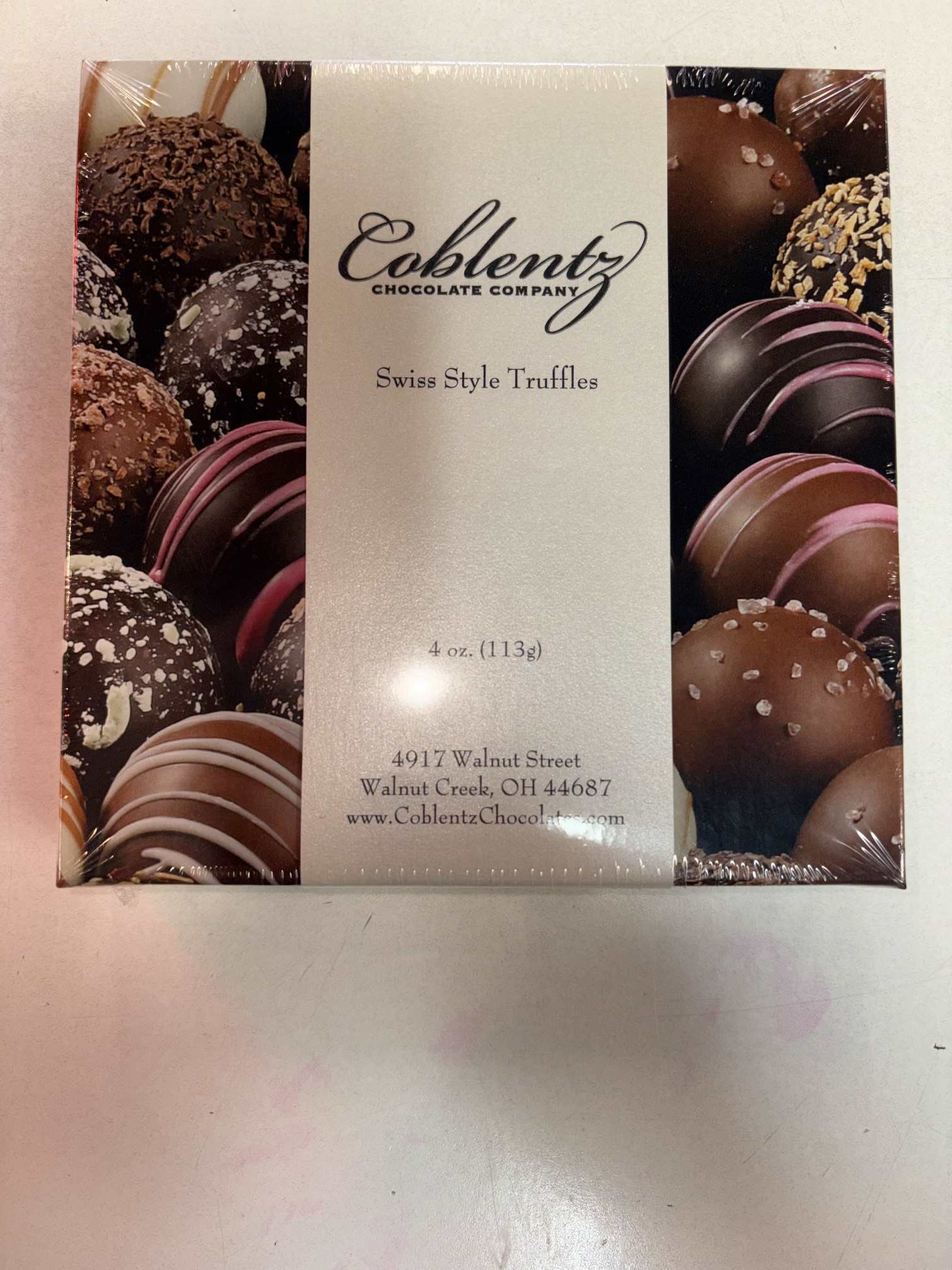 Box of assorted chocolate truffles in plastic wrap