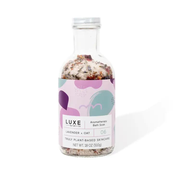 Bottle of lavender oat bath soak with a pastel label