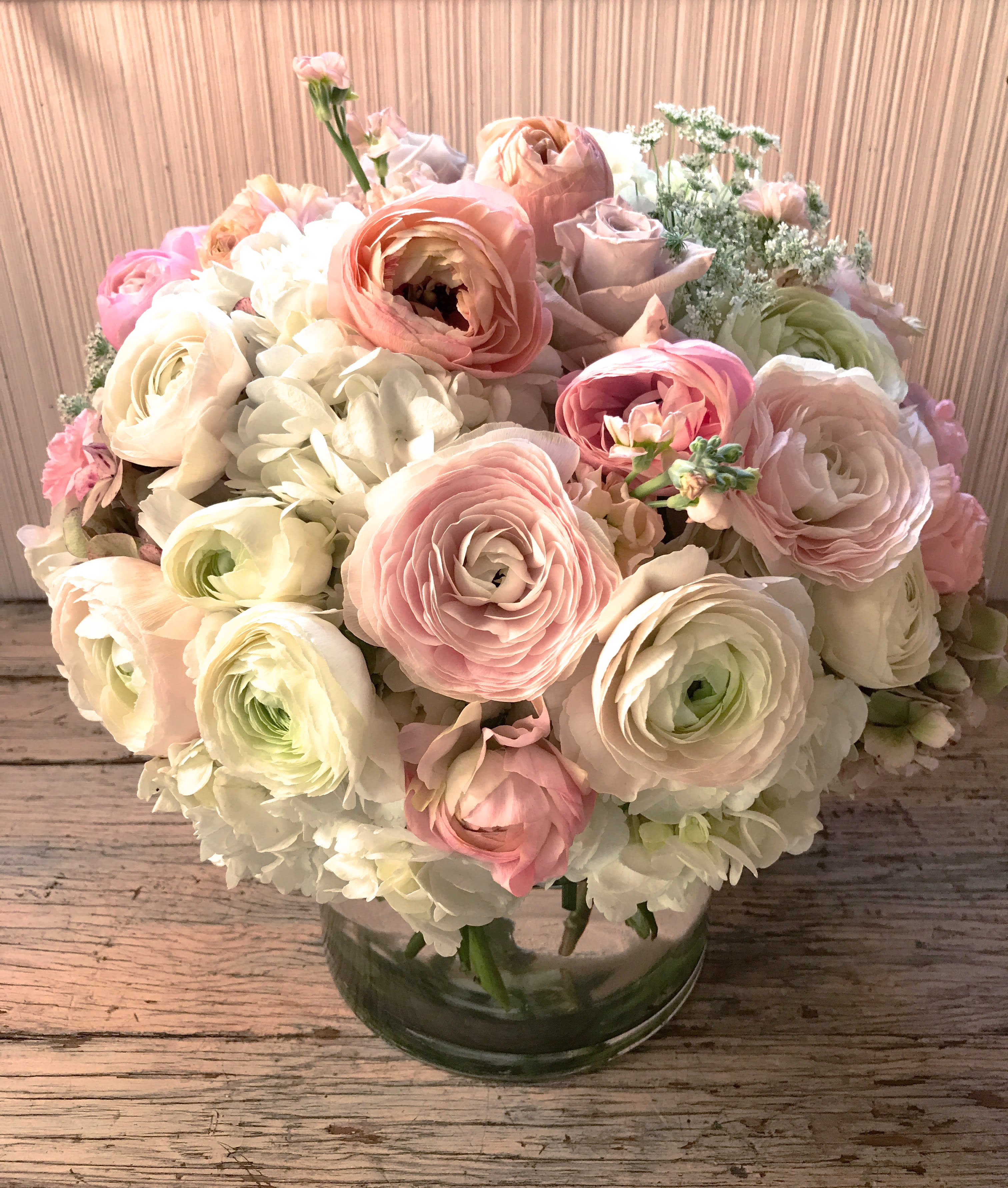 The Ida - Make an impact with this feminine arrangement in light and pretty colors. Ranunculus and roses in dreamy pallettes, hydrangeas and delicate greens make this arrangement dreamy and beautiful. placed  in a clear vase (5 by 5 inches). Choose Deluxe for a fuller and larger arrangement with more flowers. Choose premium for the x-l version of the arrangement with even more flowers. Blomst LA only uses fresh, high quality flowers, all carefully selected every day to fit your flower order. You can see the design made for happy customer on images shown, at different times of year (with a slight variation on the flowers). We offer a personal hand delivery by our own delivery staff and guarantee the flowers will look perfect, when they arrive. We deliver in Glendale, Pasadena, Eagle Rock, Hollywood, Burbank, Beverly Hills - and everywhere else in Greater Los Angeles.