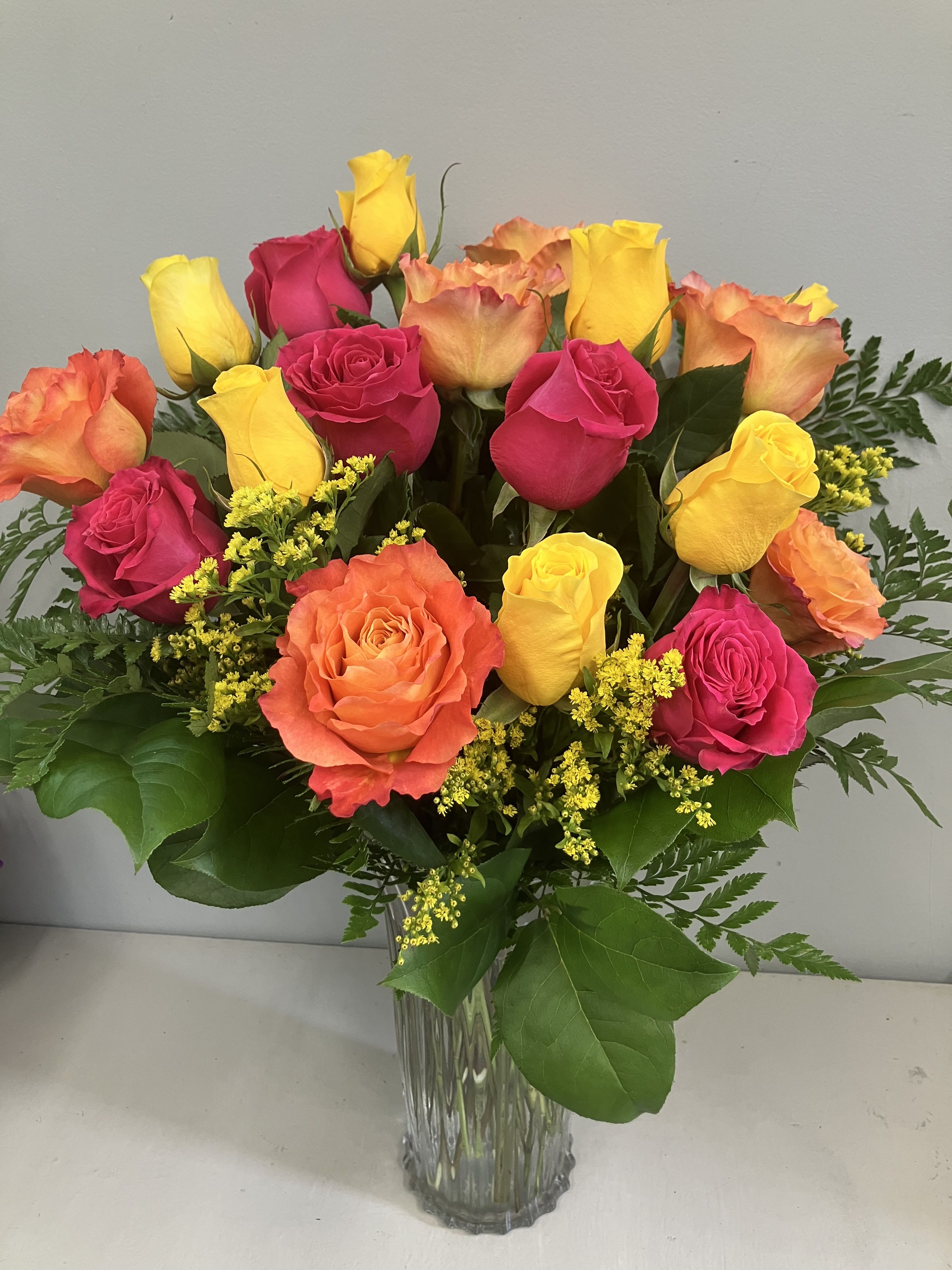 The Sound of Joy by BloomNation™ - Send an explosion of color with this long-stemmed rose arrangement perfect for celebrations or showing your appreciation. A great alternative to the classic red rose, send a giant arrangement of multicolored bright roses. 18 roses Approximate Dimensions: 20''D x 28""H