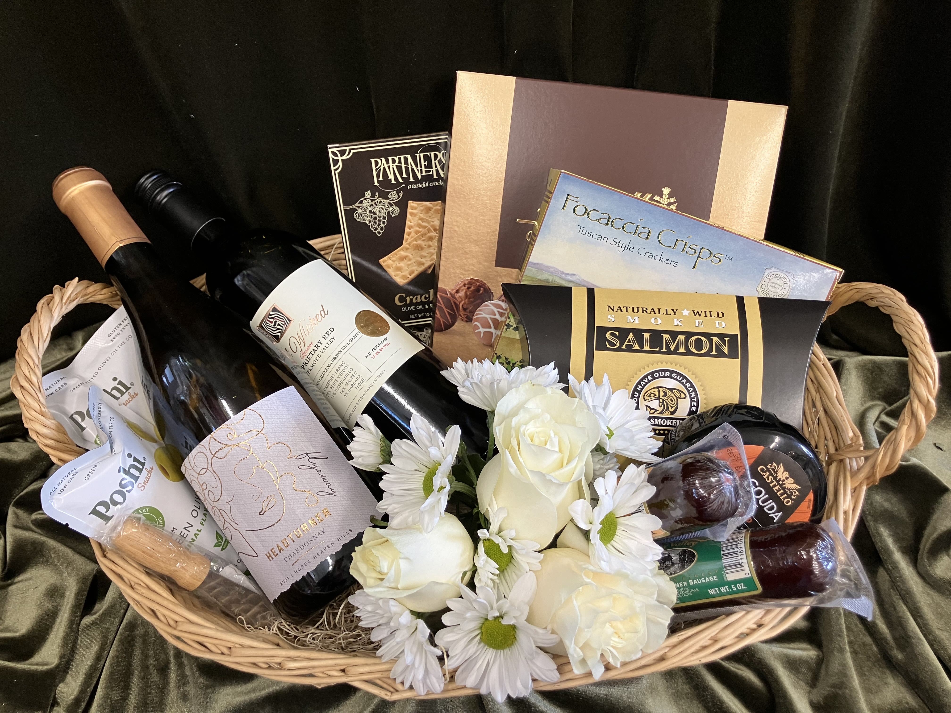 Wine Country Gourmet Basket - Send an outstanding gift basket that includes, two bottles of wine, cheese, two meats, crackers, dark chocolate salted caramels and a sweet flower arrangement of white rose and alstroemerias. Guaranteed to impress, a gift for many occasions