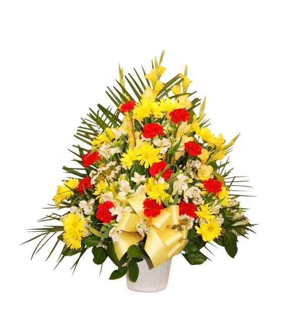 Yellow and red floral arrangement in a white vase with a ribbon