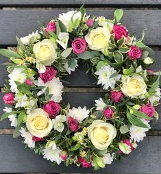 Floral wreath with cream and pink roses and white daisies