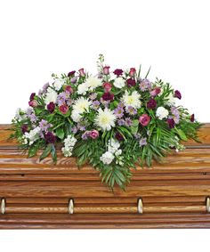 Casket spray with white and purple flowers