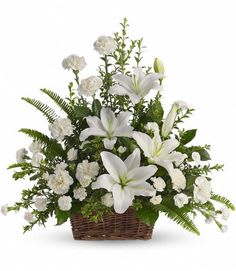 White lilies and carnations in a wicker basket