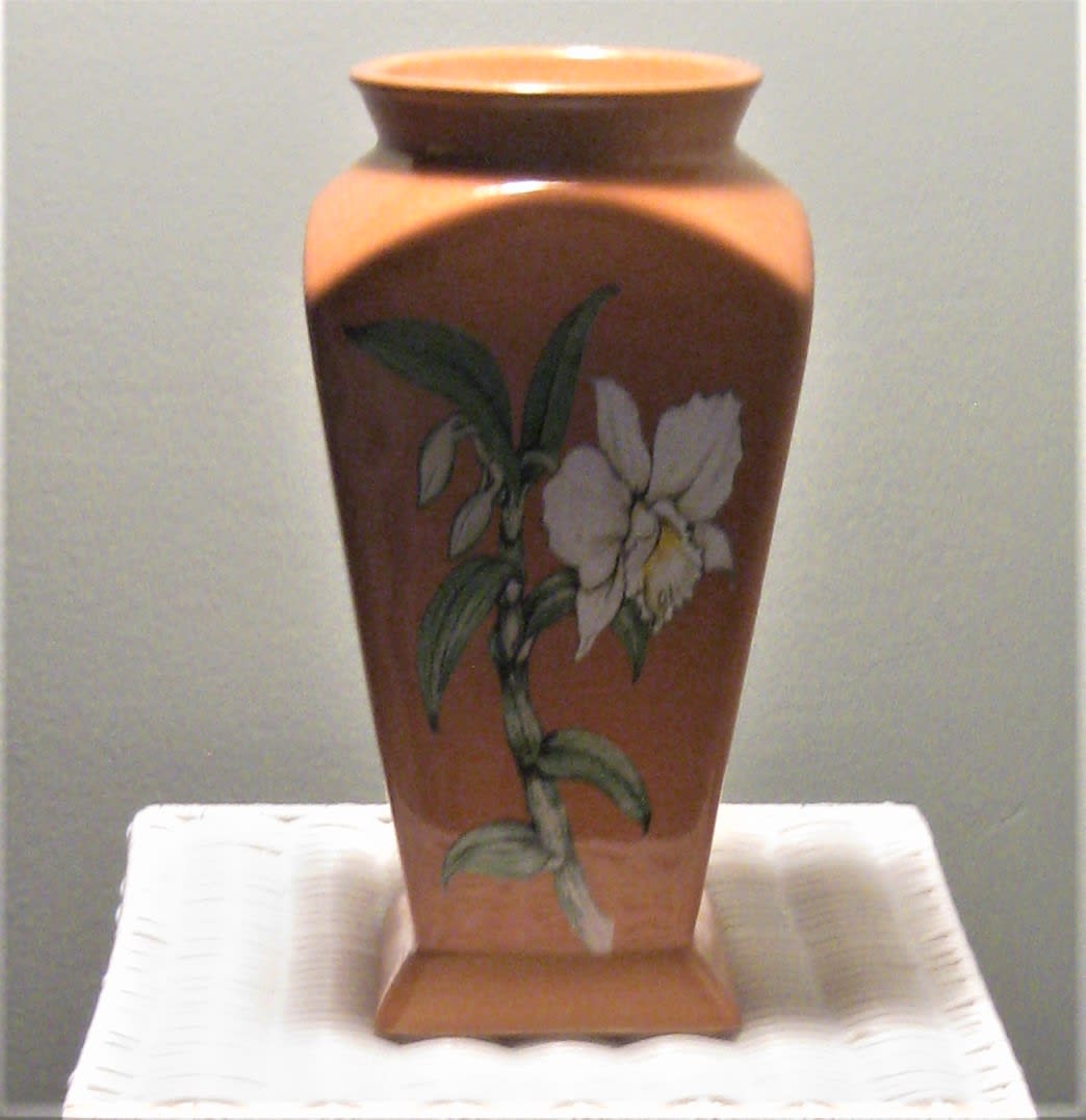 Decorative ceramic vase with a painted white flower motif