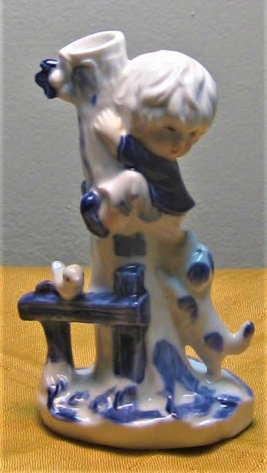 Ceramic figurine of a child hugging a dog