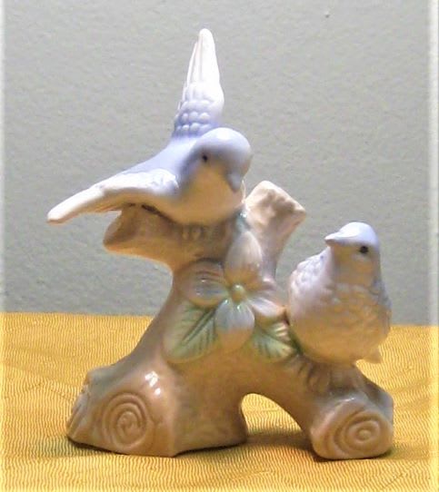 Ceramic figurine of two birds on a branch