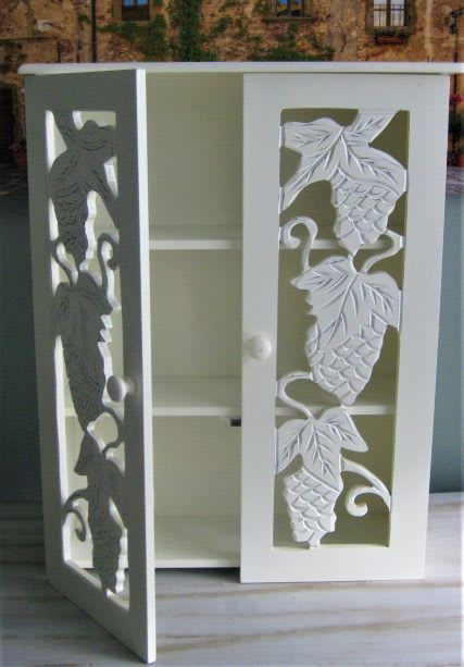 Decorative white cabinet with carved fish panels