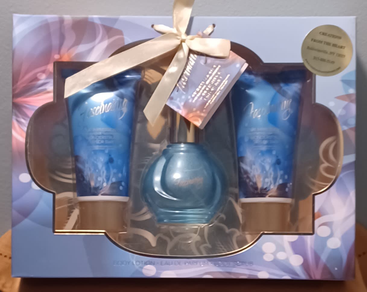 Gift set with two blue lotion tubes and a blue perfume bottle in a box