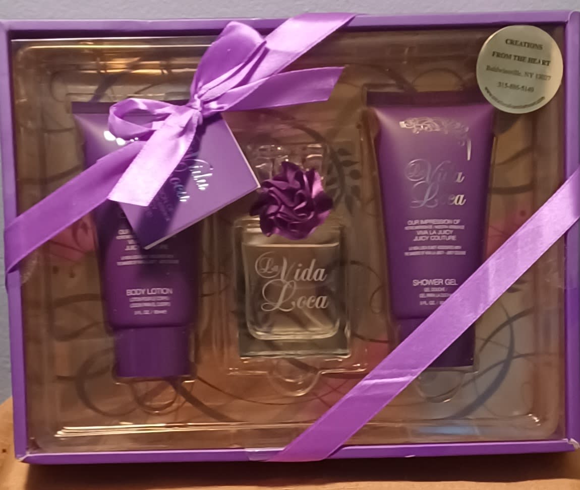 Purple gift set with lotion, perfume, and shower gel in a ribbon-tied box