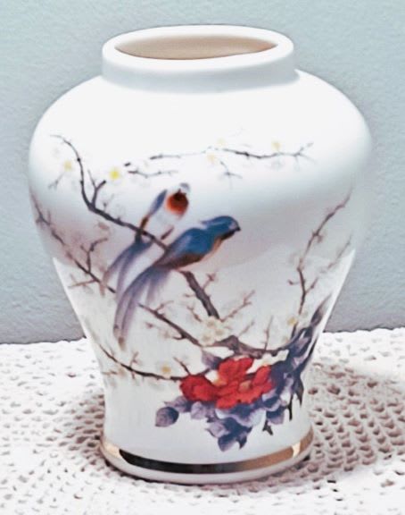 White ceramic vase with painted birds and blossoms