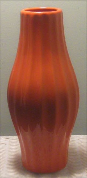 Orange ceramic vase with a tapered, rounded shape