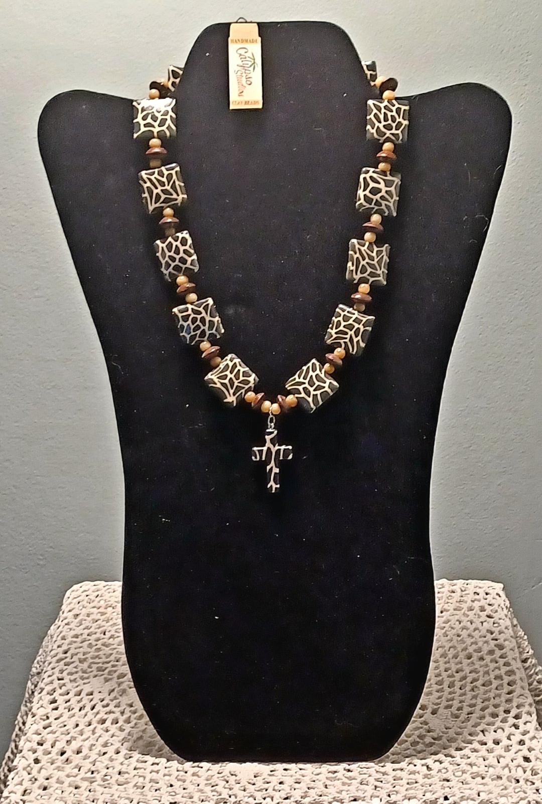 Beaded necklace displayed on a black bust stand