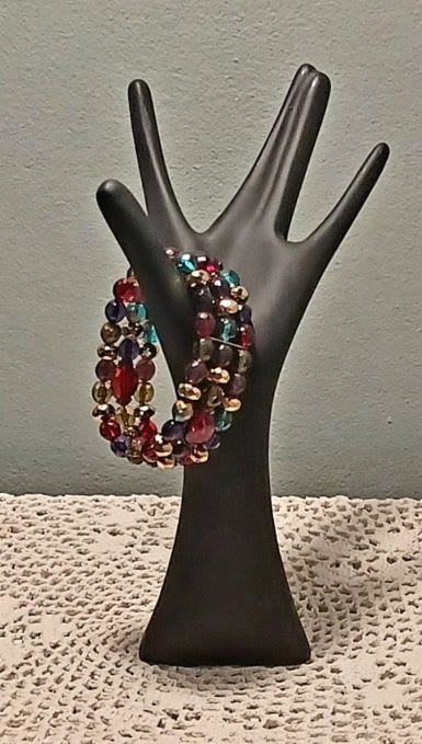 Beaded multicolor bracelet on a black hand display stand