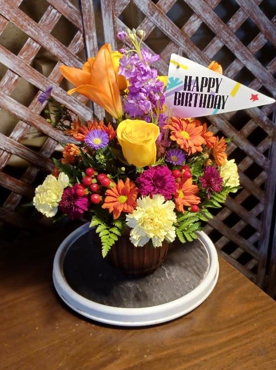 Colorful mixed bouquet in a vase with a Happy Birthday sign