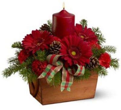 Red candle centerpiece with red flowers in a wooden box
